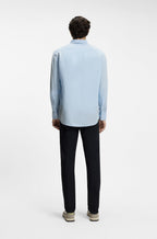 Modelo de costas com a camisa de linho azul claro da BOSS para homem.